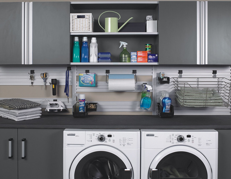 custom laundry organization with shelves and cabinets